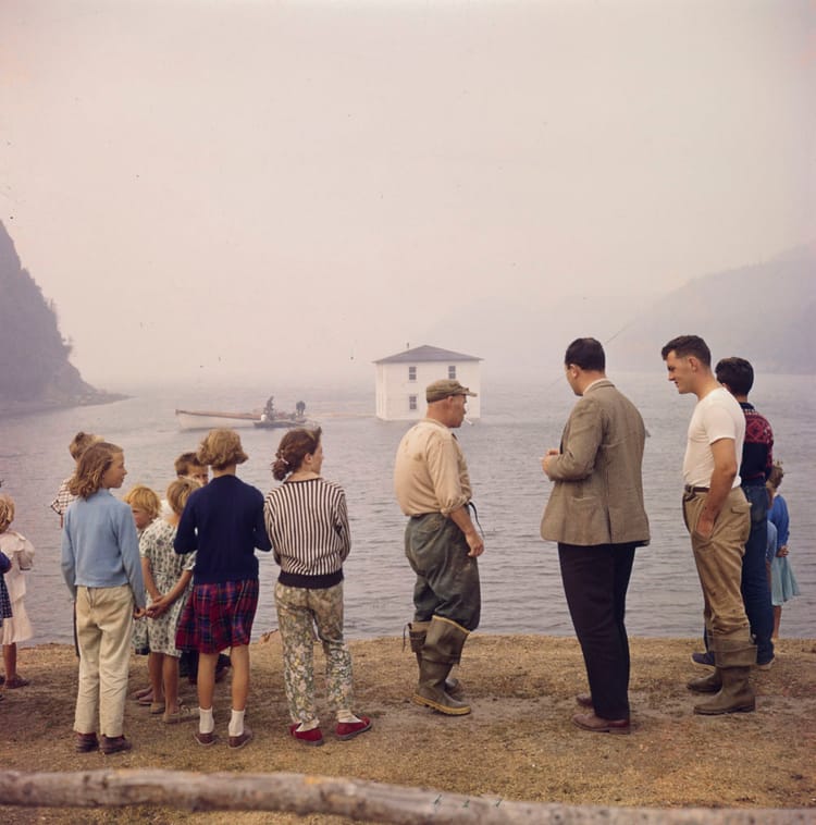 A house being moved by floating it from Silver Fox Island, Bonavista Bay, to Dover, Newfoundland, 1961 Photo: Bob Brooks 
